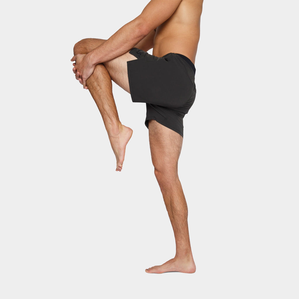 Flow Men's Lined Hot Yoga Shorts 5 Inch in faded black, showcasing flexibility and comfort during yoga practice.