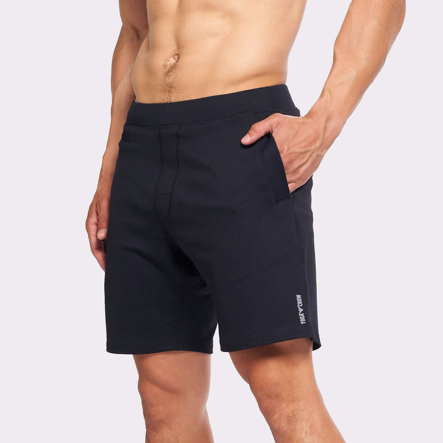 Model wearing 4-way stretch Swerve Shorts in Crow Black, showcasing comfort and flexibility for active movement.