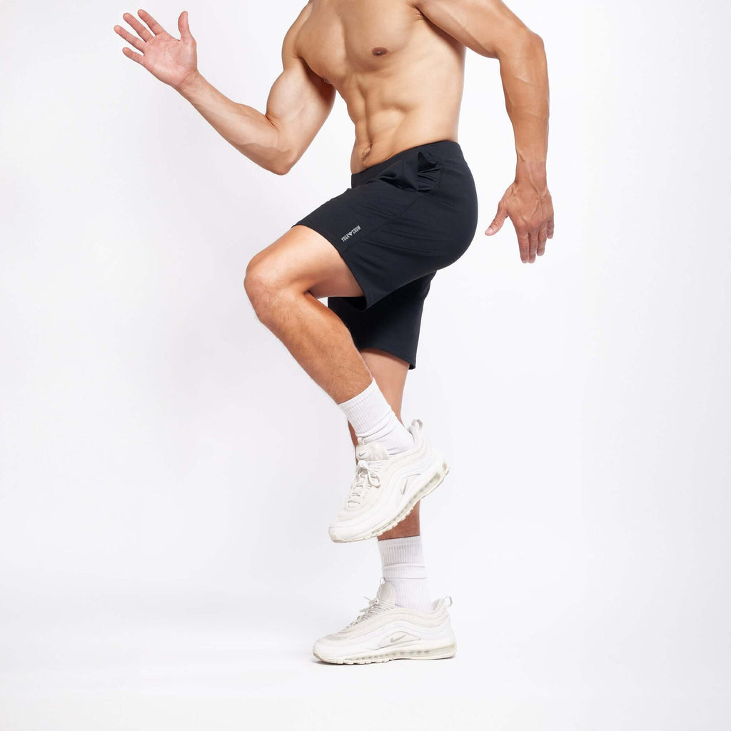 Model demonstrating active movement in 4-way stretch Swerve Shorts in Crow Black, perfect for serious training.