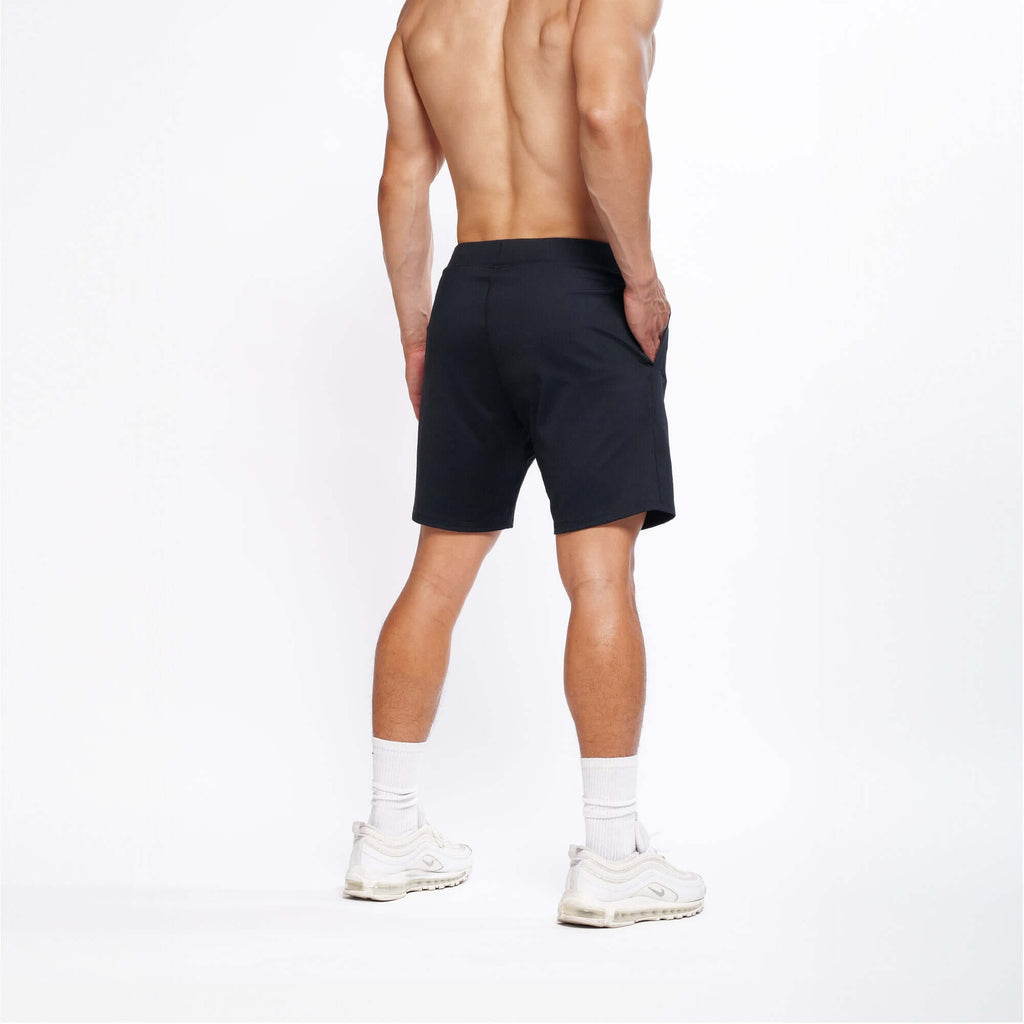 Model showcasing 4-way stretch Swerve Shorts in Crow Black from the back, highlighting comfort and flexibility.